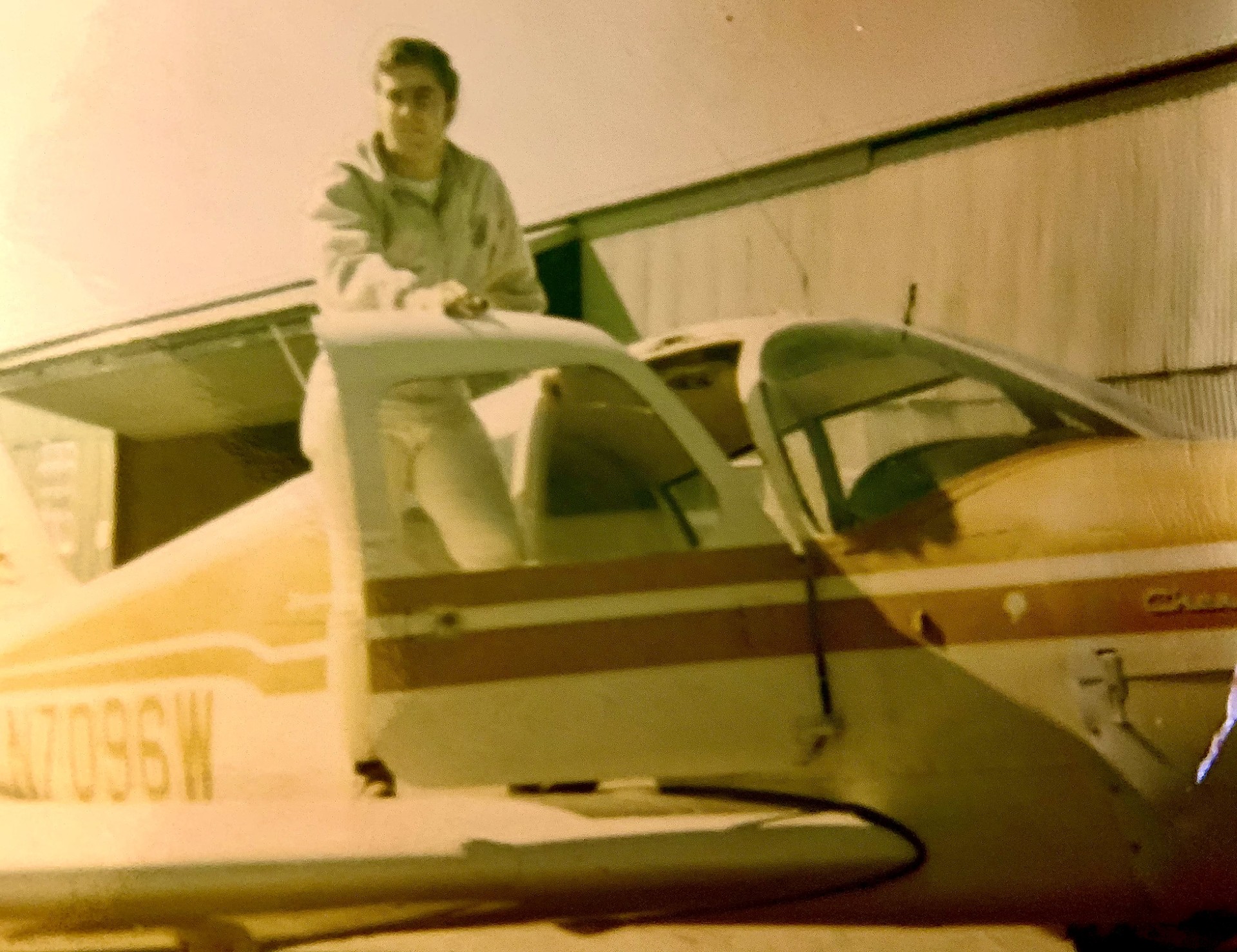 Vintage photo of Jim Fogarty on the wing of his airplane
